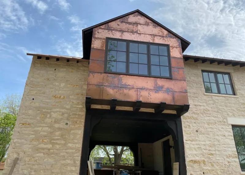 Copper metal panel facade on a stone building for Roof Repair in Willoughby Hills