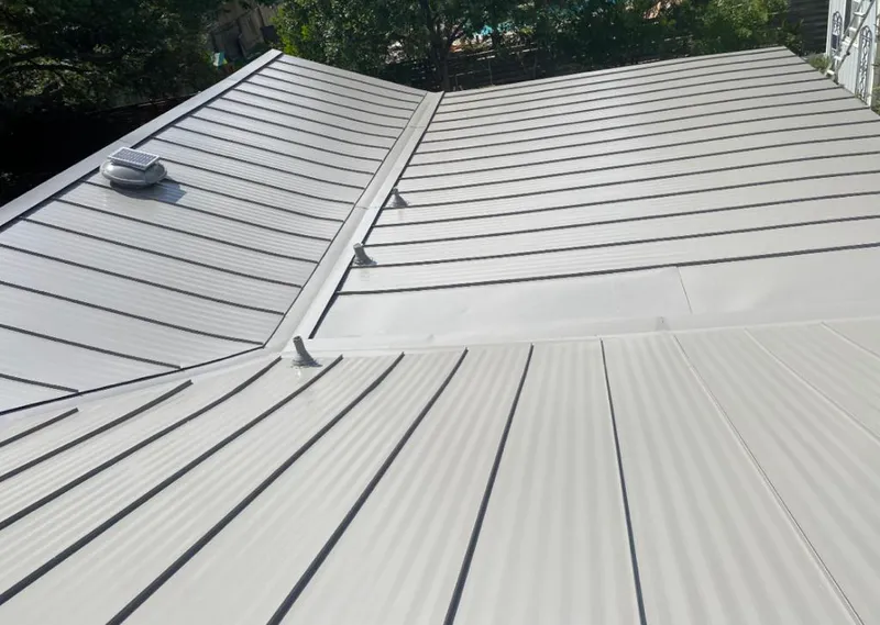 Solar attic fan installed on a metal roof for Roof Ventilation in Willoughby Hills
